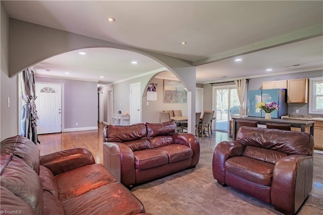 living area with plenty of natural light, arched walkways, and recessed lighting