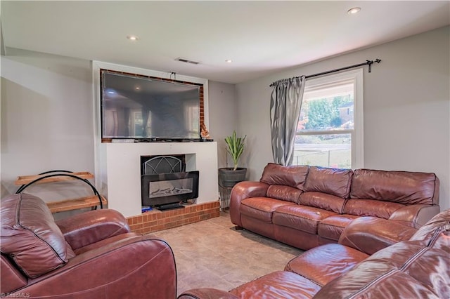 tiled living room with visible vents, a fireplace, and recessed lighting