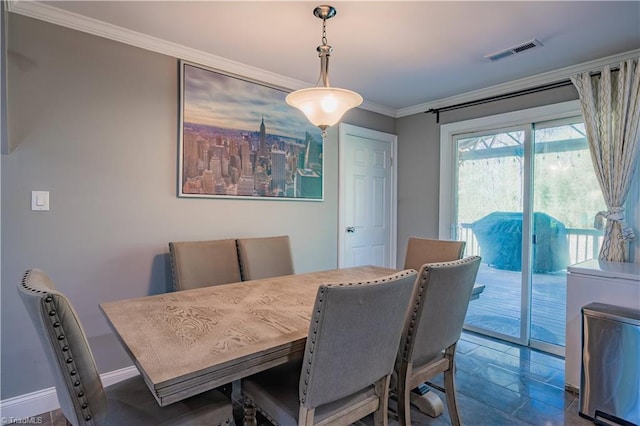 dining room with baseboards, visible vents, and ornamental molding