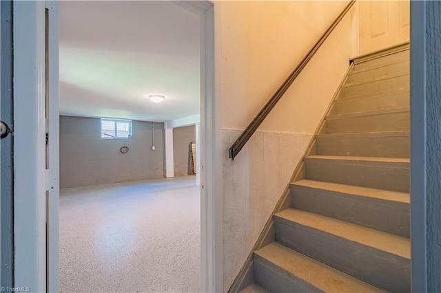 staircase with concrete block wall