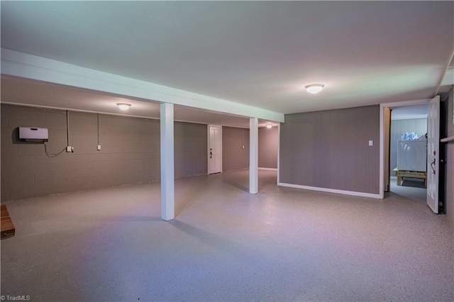 finished below grade area featuring concrete block wall
