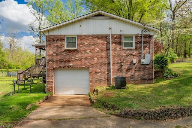 view of property exterior with fence, brick siding, a yard, and a garage