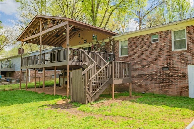 exterior space with fence, a yard, and stairs