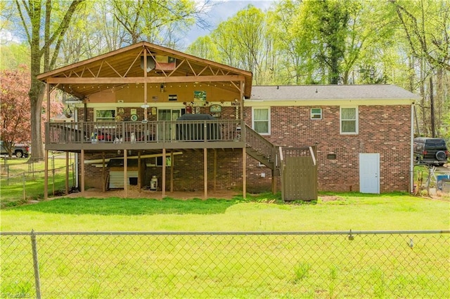 rear view of house with a fenced backyard, a wooden deck, and stairway