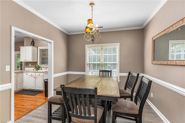 1515 Klompen Rd, Kernersville, NC 27284 - dining area with a chandelier, light wood-type flooring, plenty of natural light, crown molding, and baseboards