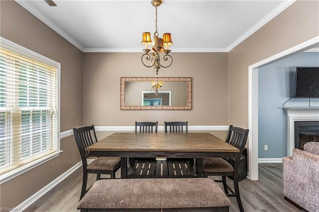 1515 Klompen Rd, Kernersville, NC 27284 - dining space featuring wood finished floors, crown molding, baseboards, and a chandelier