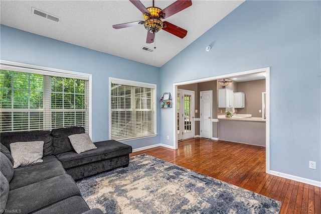 1515 Klompen Rd, Kernersville, NC 27284 - living area with baseboards, hardwood / wood-style floors, a ceiling fan, a textured ceiling, and high vaulted ceiling