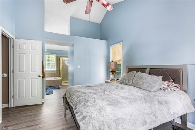 1515 Klompen Rd, Kernersville, NC 27284 - bedroom featuring high vaulted ceiling, wood finished floors, baseboards, connected bathroom, and ceiling fan