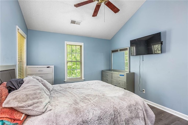 1515 Klompen Rd, Kernersville, NC 27284 - bedroom with dark wood-style floors, baseboards, vaulted ceiling, a textured ceiling, and a ceiling fan