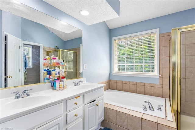 1515 Klompen Rd, Kernersville, NC 27284 - full bathroom featuring a stall shower, a textured ceiling, a bath, and double vanity