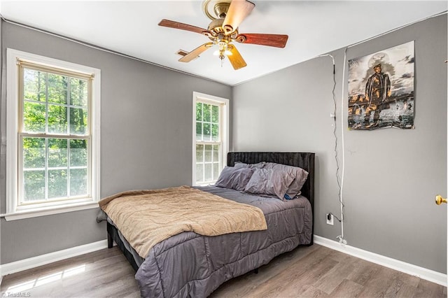 1515 Klompen Rd, Kernersville, NC 27284 - bedroom with baseboards, wood finished floors, and a ceiling fan
