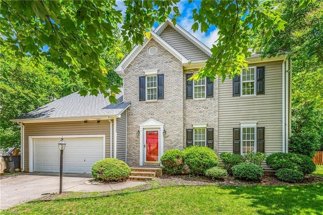 1515 Klompen Rd, Kernersville, NC 27284 - view of front of home featuring driveway, an attached garage, a front yard, and brick siding