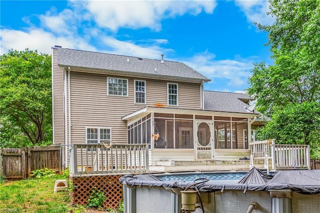1515 Klompen Rd, Kernersville, NC 27284 - rear view of house with a sunroom, a wooden deck, a covered pool, and a shingled roof