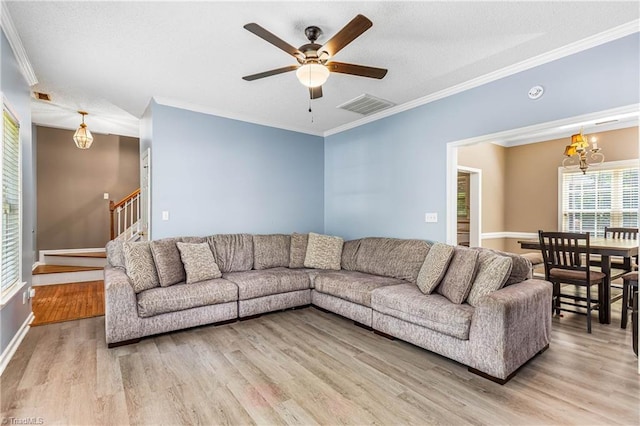 1515 Klompen Rd, Kernersville, NC 27284 - living room with light wood-style floors, a chandelier, ceiling fan, crown molding, and stairway