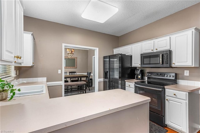 1515 Klompen Rd, Kernersville, NC 27284 - kitchen with black / electric stove, refrigerator with ice dispenser, a sink, light countertops, and white cabinets