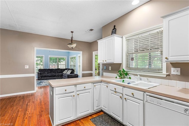 1515 Klompen Rd, Kernersville, NC 27284 - kitchen featuring white dishwasher, a sink, a peninsula, white cabinets, and light countertops