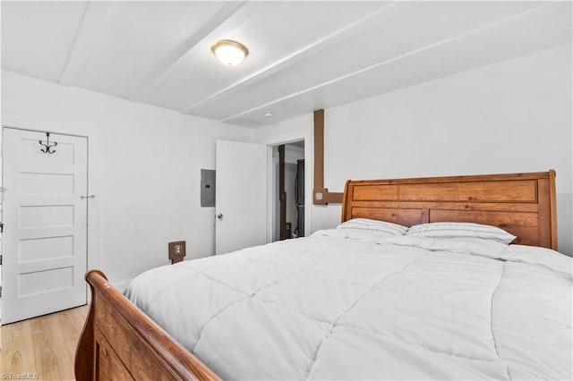 bedroom with light hardwood / wood-style floors and electric panel