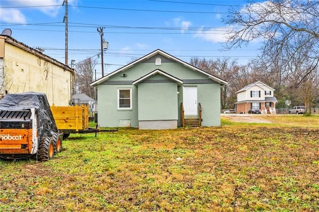 rear view of house with a lawn