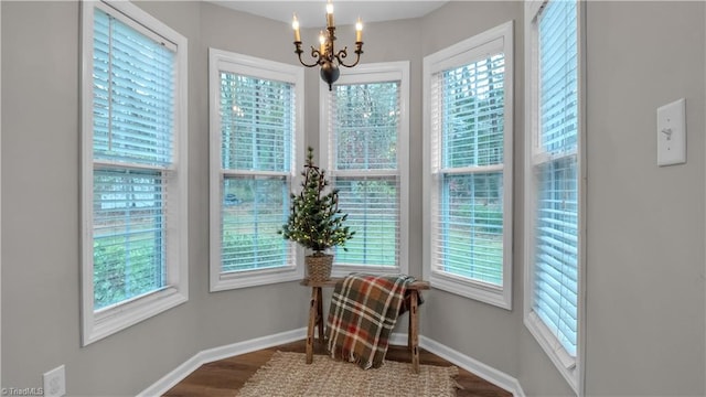 sitting room featuring hardwood / wood-style flooring and an inviting chandelier