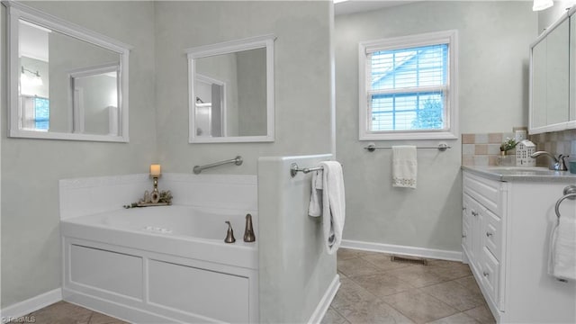 bathroom featuring tile patterned floors, a bathtub, and vanity