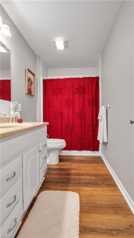 bathroom featuring a shower with curtain, vanity, toilet, and wood-type flooring