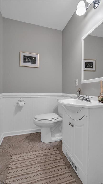 bathroom with tile patterned floors, vanity, and toilet