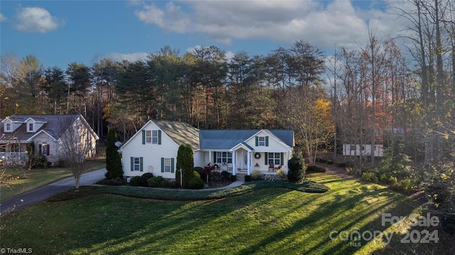 view of front of property with a porch and a front lawn