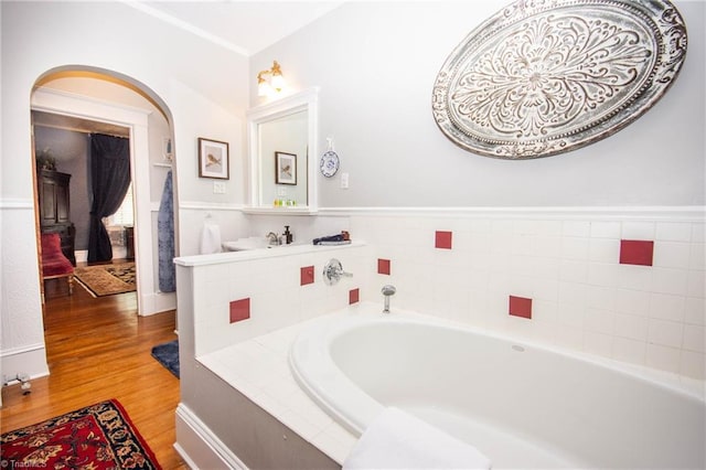 bathroom featuring a bath and hardwood / wood-style flooring