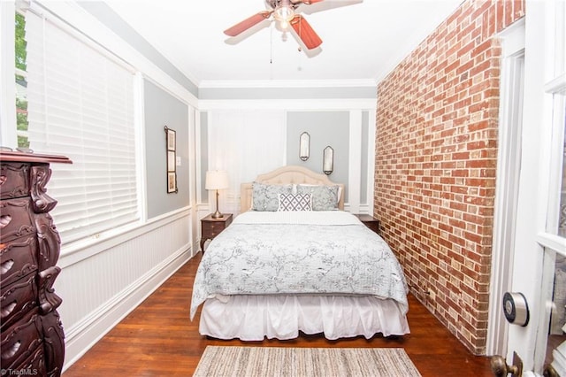 bedroom with ceiling fan, crown molding, brick wall, and dark hardwood / wood-style floors