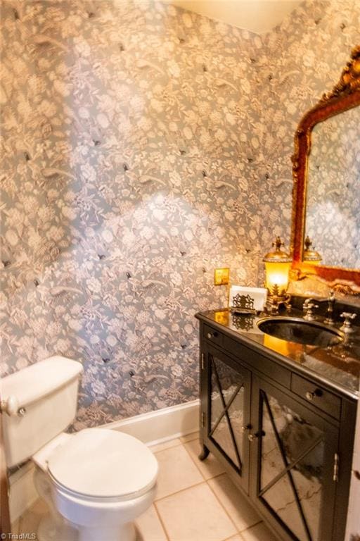 bathroom featuring toilet, tile floors, and vanity