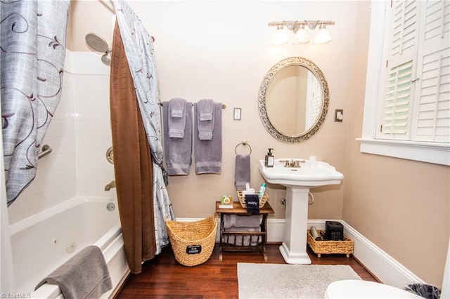 bathroom featuring shower / bath combination with curtain, toilet, and hardwood / wood-style floors