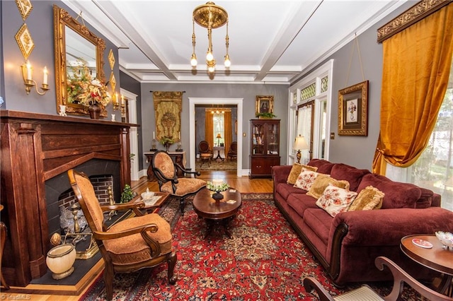 living area with beam ceiling, a chandelier, hardwood / wood-style flooring, and ornamental molding