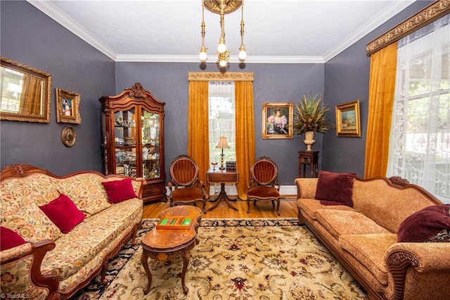 living room with an inviting chandelier, a wealth of natural light, and hardwood / wood-style flooring