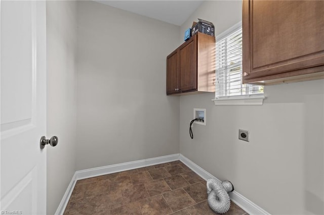clothes washing area featuring electric dryer hookup, cabinet space, baseboards, and hookup for a washing machine