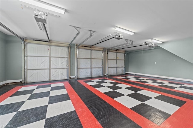 garage featuring a garage door opener and baseboards