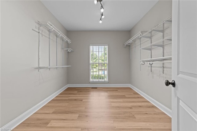 spacious closet with wood finished floors