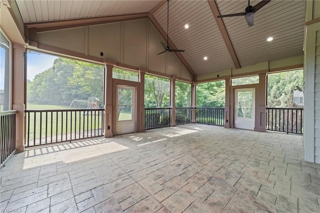 unfurnished sunroom featuring ceiling fan