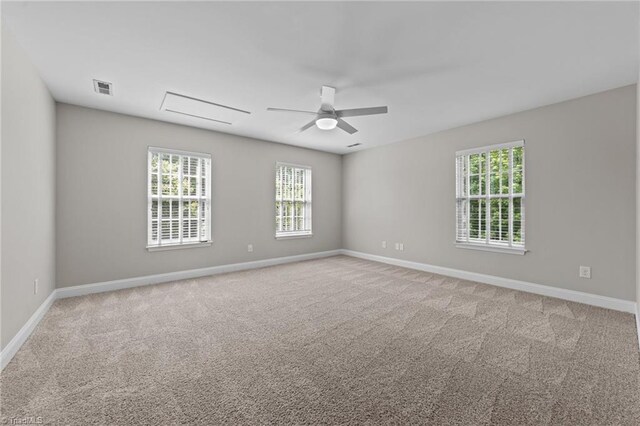 unfurnished room with ceiling fan, light carpet, and baseboards