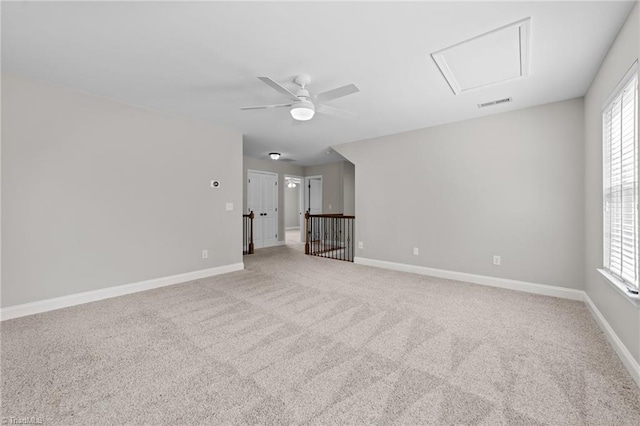 spare room with light colored carpet, healthy amount of natural light, and a ceiling fan
