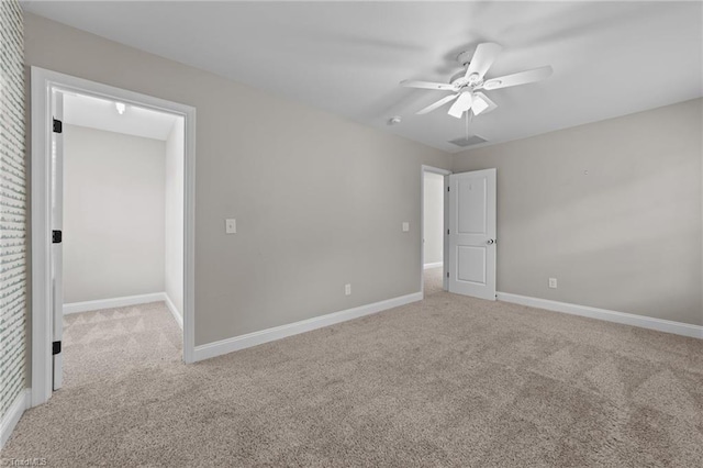 unfurnished bedroom featuring carpet flooring, baseboards, and a ceiling fan