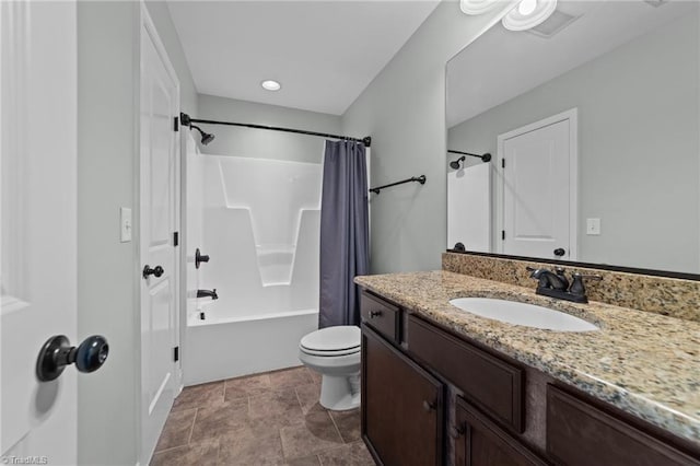 full bathroom featuring toilet, vanity, shower / bath combination with curtain, stone finish flooring, and baseboards