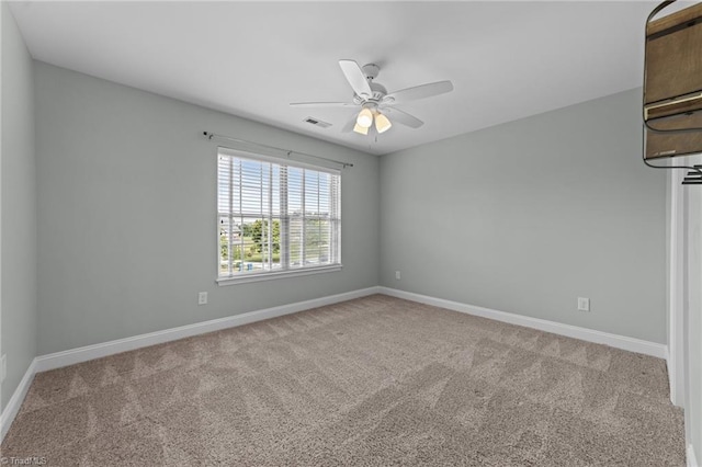 carpeted spare room with baseboards and ceiling fan