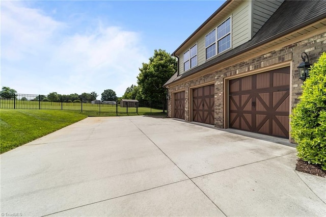 view of side of home featuring driveway and a garage