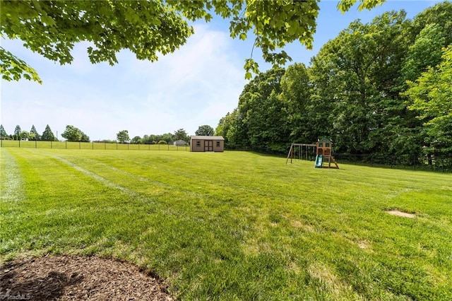 view of yard with a playground, a shed, and an outdoor structure
