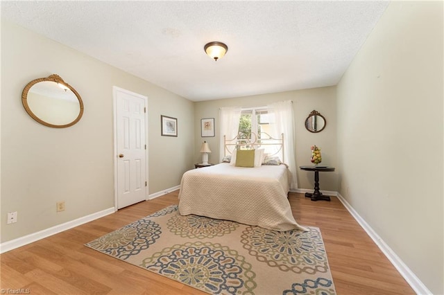 944 Chatfield Dr, Jamestown, NC 27282 - bedroom with light wood-style flooring and a textured ceiling