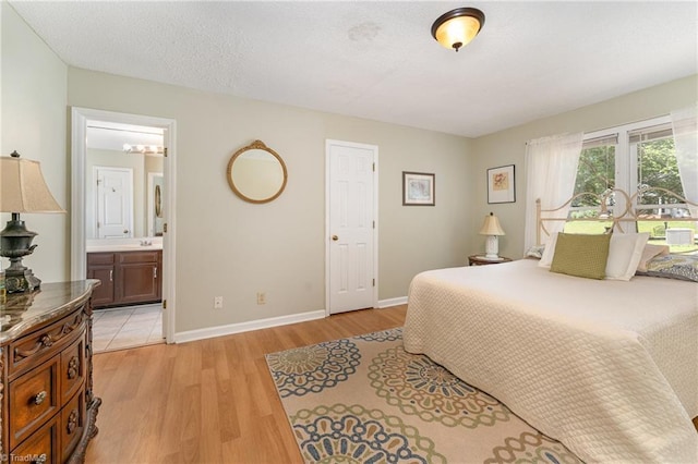 944 Chatfield Dr, Jamestown, NC 27282 - bedroom with light wood-style flooring and ensuite bath