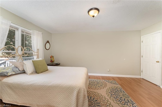944 Chatfield Dr, Jamestown, NC 27282 - bedroom featuring wood finished floors and a textured ceiling