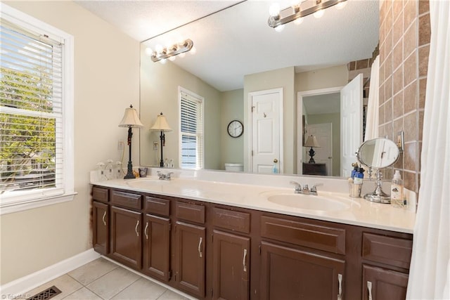 944 Chatfield Dr, Jamestown, NC 27282 - full bathroom with tile patterned floors, double vanity, and a textured ceiling