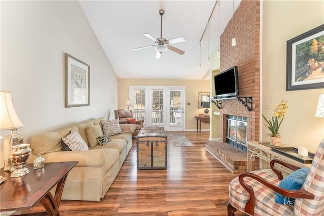 944 Chatfield Dr, Jamestown, NC 27282 - living area with ceiling fan, high vaulted ceiling, wood finished floors, and a brick fireplace