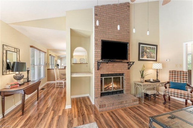 944 Chatfield Dr, Jamestown, NC 27282 - living room with wood finished floors, plenty of natural light, a fireplace, and high vaulted ceiling